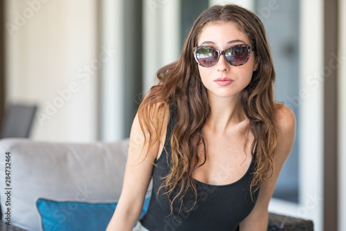 Photo of a beautiful woman in stylish sunglasses