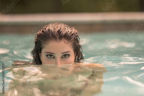 Attractive young woman sticking her head out of the water