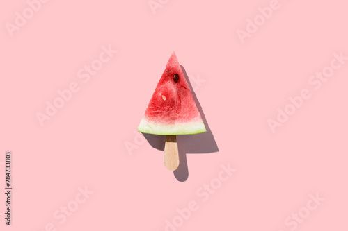 Watermelon slice popsicles on a pink color background