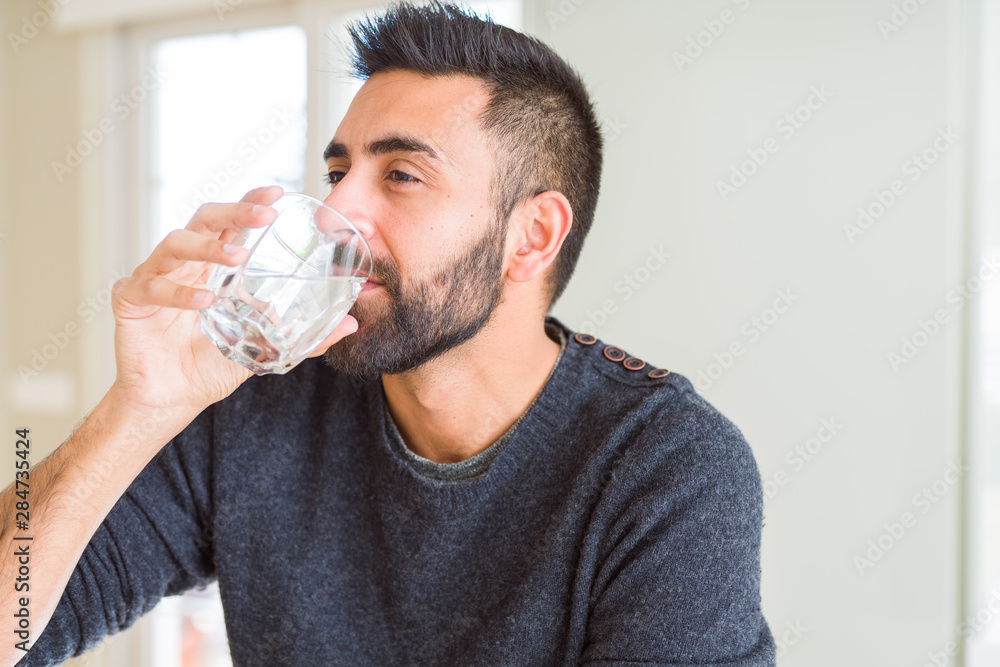 Handsome man drinking a fresh glass of water Handsome man drinking a fresh glass of water