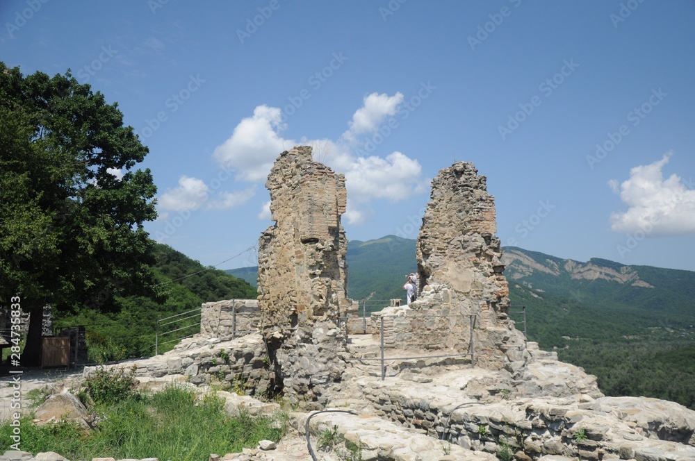 The ruins of the ancient walls of the Georgian fortress Ujarma against the backdrop of the Caucasus Mountains