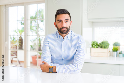 Handsome hispanic business man Relaxed with serious expression on face. Simple and natural looking at the camera. © Krakenimages.com