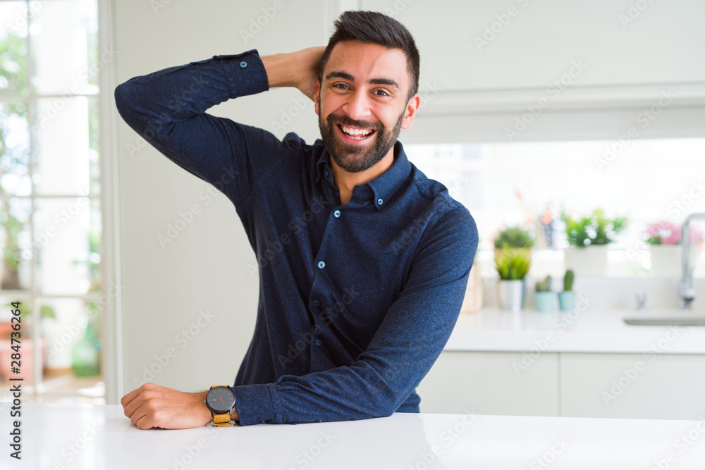 Handsome man smiling cheerful with a big smile on face showing teeth, positive and happy expression Handsome man smiling cheerful with a big smile on face showing teeth, positive and happy expression