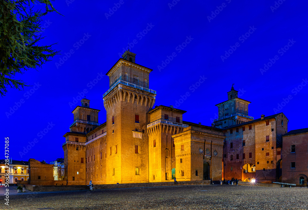 Castle Estense (Castello Estense) in Ferrara, Emilia-Romagna, Italy. Ferrara is capital of the Province of Ferrara. Night cityscape of Ferrara