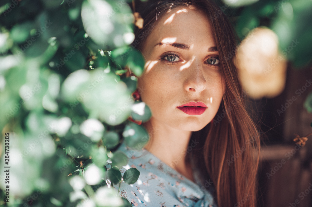 Fashion portrait of young brunette female model in the bushes Fashion portrait of young brunette female model in the bushes