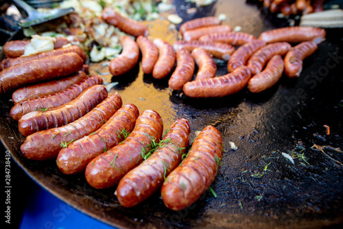 Tasty and juicy meat sausages are grilled. Street food concept.