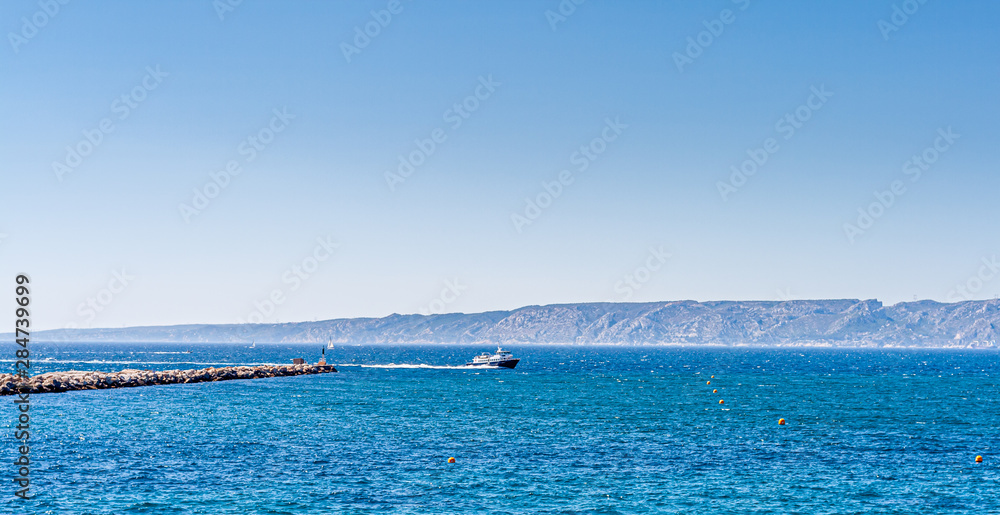 boat running in the sea with mountains on background