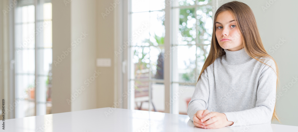 Wide angle picture of beautiful young girl kid wearing casual sweater depressed and worry for distress, crying angry and afraid. Sad expression. Wide angle picture of beautiful young girl kid wearing casual sweater depressed and worry for distress, crying angry and afraid. Sad expression.