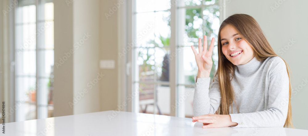 Wide angle picture of beautiful young girl kid wearing casual sweater showing and pointing up with fingers number four while smiling confident and happy. Wide angle picture of beautiful young girl kid wearing casual sweater showing and pointing up with fingers number four while smiling confident and happy.