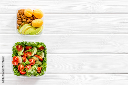 healthy meal in lunch box to take away on white wooden background top view mockup
