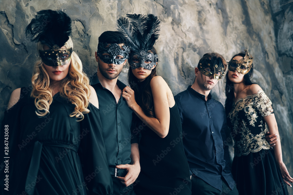 Group of people in masquerade carnival mask posing in studio - obrazy, fototapety, plakaty 