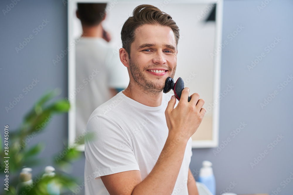 Portrait of adult man shaving in the bathroom Portrait of adult man shaving in the bathroom
