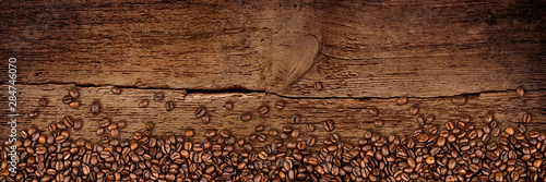 fresh roasted coffee beans natural dark oak wood panorama wide plank wooden closeup macro background