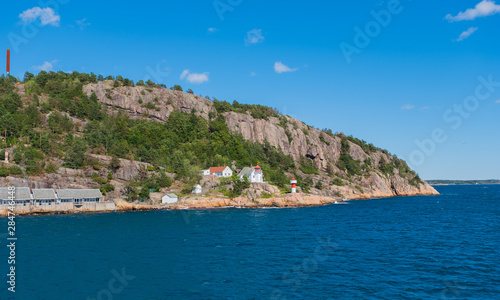 Beautiful seascape norwegian coastline, coast of Kristiansand with small lighthouse, Scandinavia, Norway. July 2019