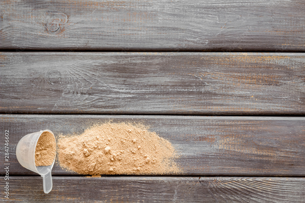 Nutrition for workout with protein cocktail powder on wooden background top view mockup Nutrition for workout with protein cocktail powder on wooden background top view mockup