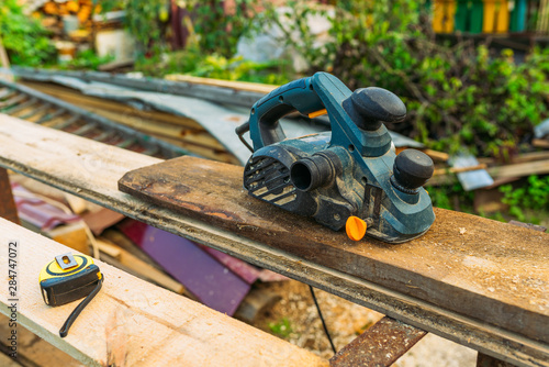 Blue plane with tape measure on the workbench photo