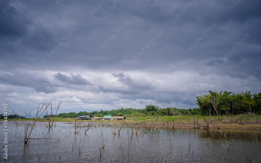 countryside near the lake with raincloud