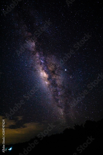 Night landscape with the Milky Way and light from home at mountains in Thailand