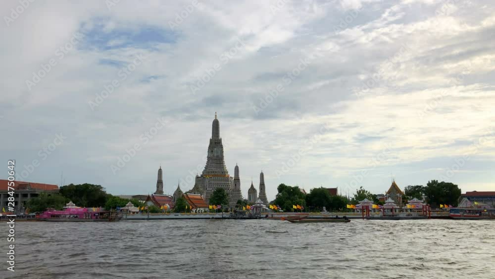 Landmark of Temple of Wat Arun with Chao Phraya River and Passenger ship in Bangkok, Thailand day to night. Is an important destination for tourists around the world. 4K Ultra HD Landmark of Temple of Wat Arun with Chao Phraya River and Passenger ship in Bangkok, Thailand day to night. Is an important destination for tourists around the world. 4K Ultra HD