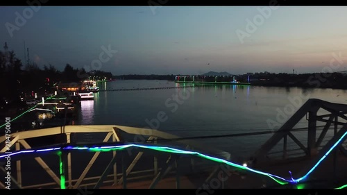 Drone flying above early morning traffic and birds on Entanou Bridge at sunrise, Praek Tuek Chuu river, Kampot, Cambodia photo