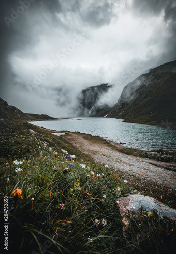 misty moody dramatic weather above beautiful lake on grossglockner mountain in austria