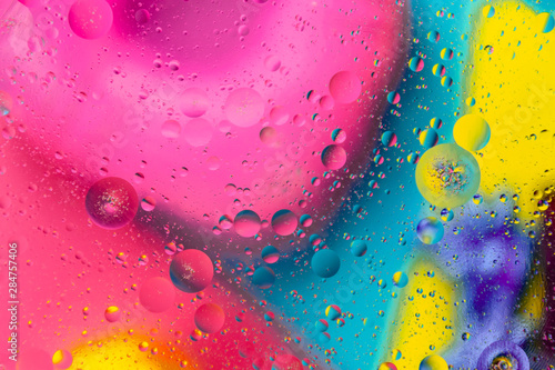 Micro molecular abstract pattern of colored oil bubbles on water. 