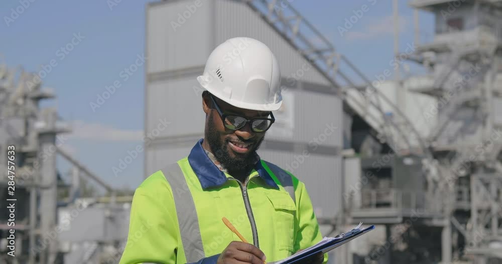 Worker with clipboard in oilfield Worker with clipboard in oilfield