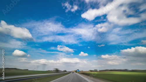 A drive on the Danish highway on a beautiful summer day.  Clouds rushing above. photo