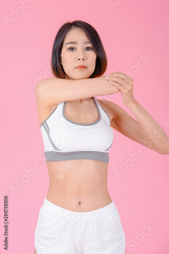sport woman standing warm-up and stretch body before doing exercise on pink backgrounds, fitness concept, sport concept © I Believe I Can Fly