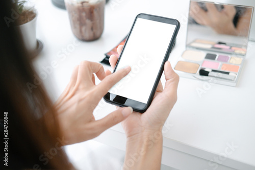 Mockup image of Beautiful woman shopping online with smartphone on online websites, mockup concept