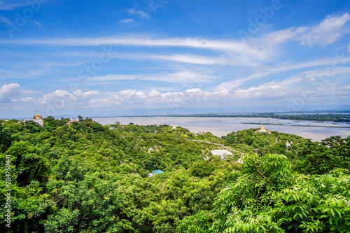 aerial view of Mandalay city with  temples  gold pagoda  Irrawaddy river and bridges from sagaing hill. landmark and popular for tourists attractions in Myanmar