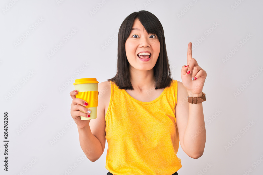 Young beautiful Chinese woman drinking take away coffee over isolated white background surprised with an idea or question pointing finger with happy face, number one Young beautiful Chinese woman drinking take away coffee over isolated white background surprised with an idea or question pointing finger with happy face, number one