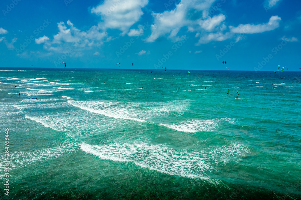 Aerial view of para surfers over the turquoise water of the Mediterranean sea 