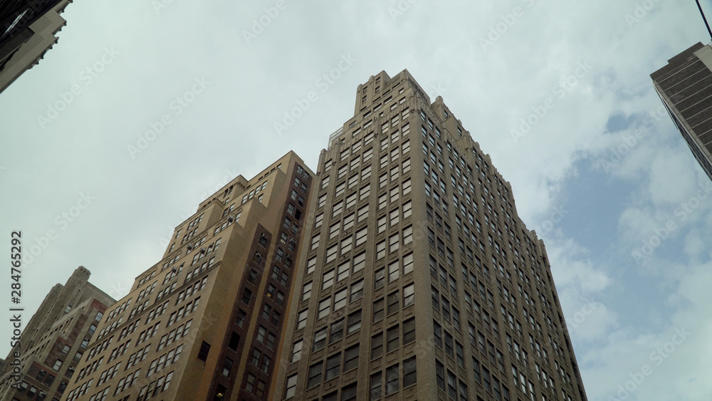 Day time exterior establishing shot looking straight up vertical at generic office apartment buildings in midtown manhattan towards the sky