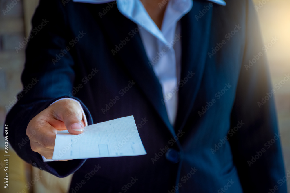 Business woman hand giving cheque.