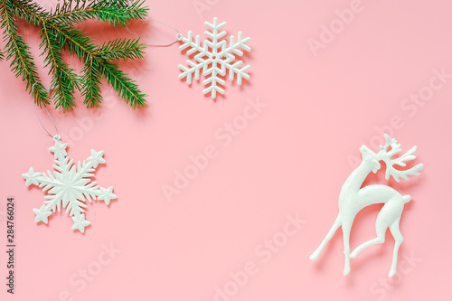 Three white christmas decoration tree toy on fir branch on pink background copy space. Concept Merry christmas or Happy new year. Minimal style Top view Flat lay Template for design, card, invitation © IRINA