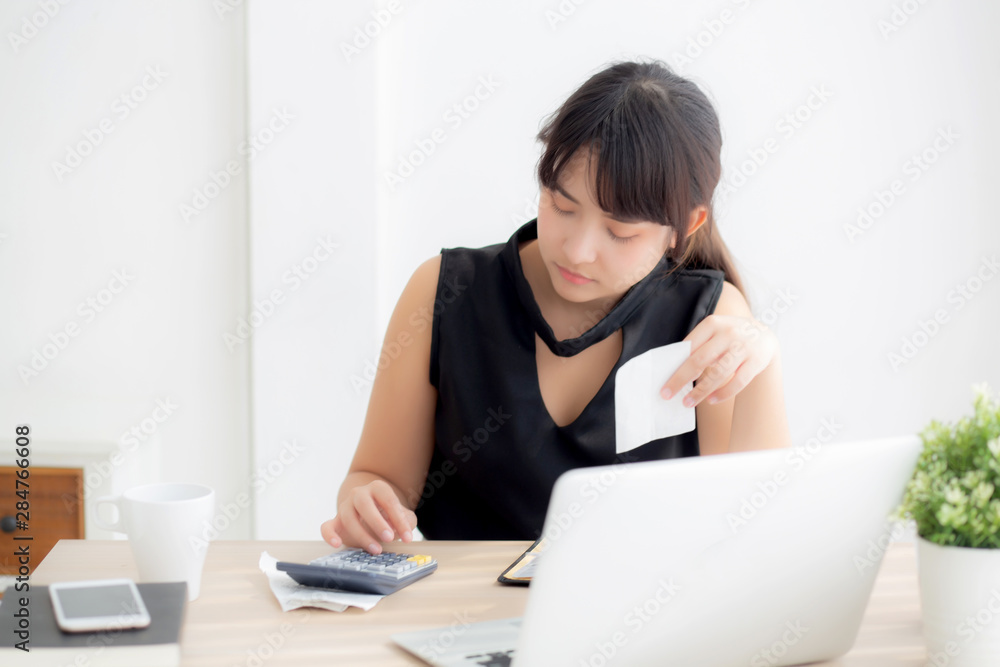 Beautiful young asian woman calculating expenses household and writing notebook on desk, girl checking bill and stress and note, female worry debt and tax, finance and business concept. Beautiful young asian woman calculating expenses household and writing notebook on desk, girl checking bill and stress and note, female worry debt and tax, finance and business concept.