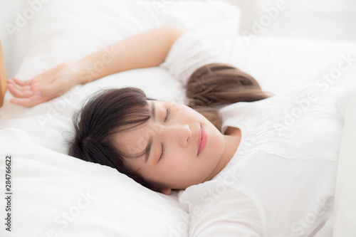 Beautiful asian young woman sleeping lying in bed with head on pillow comfortable and happy. girl with relax for health concept.