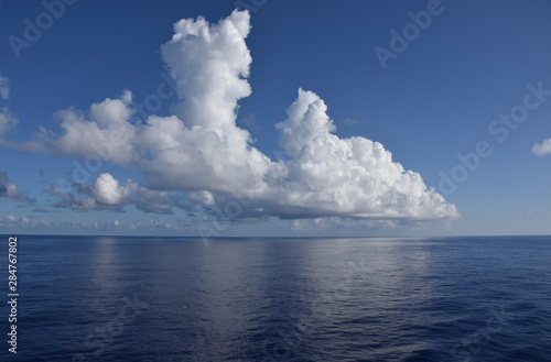 Clouds over the calm ocean.