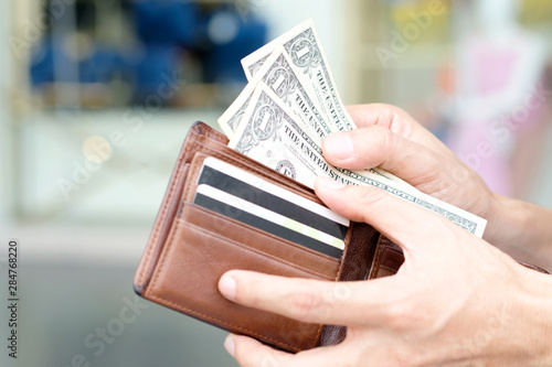 Women hold money in wallets, backgrounds, bags and fashion items.