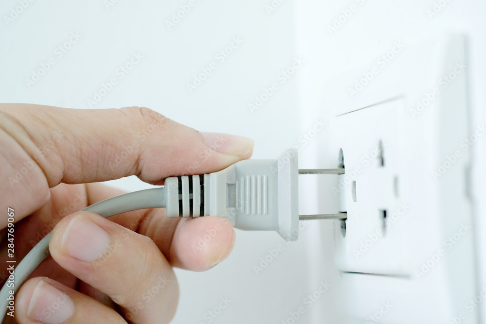 Hand of Electrical Appliances He was pulling the plug. Out of the plug. In his office during work hours. Energy Saving Concepts and Technologies Hand of Electrical Appliances He was pulling the plug. Out of the plug. In his office during work hours. Energy Saving Concepts and Technologies