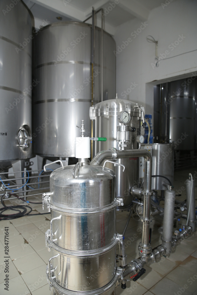 shiny tanks or barrels at a beer and wine factory. Industry Brewing and winemaking. Equipment for the winery and brewing industrial shiny tanks or barrels at a beer and wine factory. Industry Brewing and winemaking. Equipment for the winery and brewing industrial