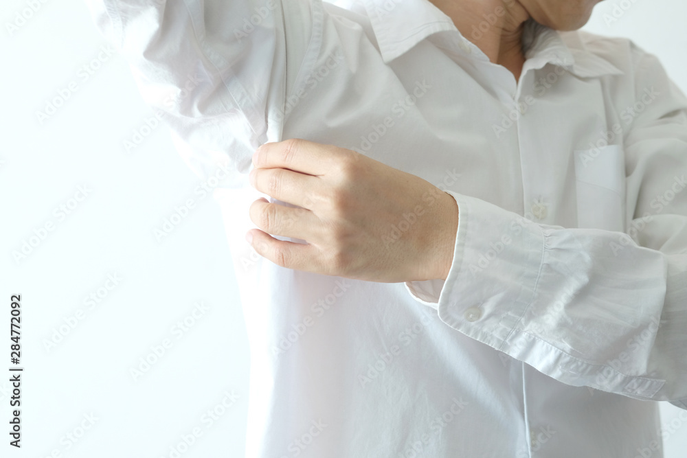 Men wear white sleeves, arms are covered with armpits, Sweat are unclean and unclean. Health care concept Men wear white sleeves, arms are covered with armpits, Sweat are unclean and unclean. Health care concept