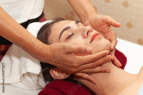 Close up of Beautiful young woman is facial massage in a spa for.healthy and relaxing at spa