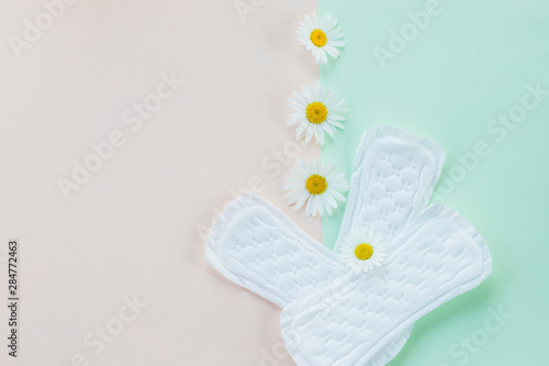 Menstruation sanitary soft pad, hygiene protection. gynecological menstruation cycle. daisy flower, chamomile and menstruation pad,sanitary napkin for every day.daily panty liners.Copy space