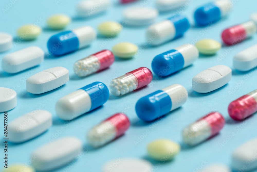 Studio shot of medical pills on blue background Studio shot of medical pills on blue background