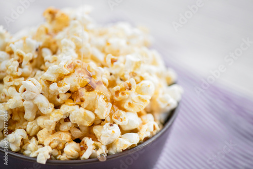 popcorn in a purple Cup on a light background