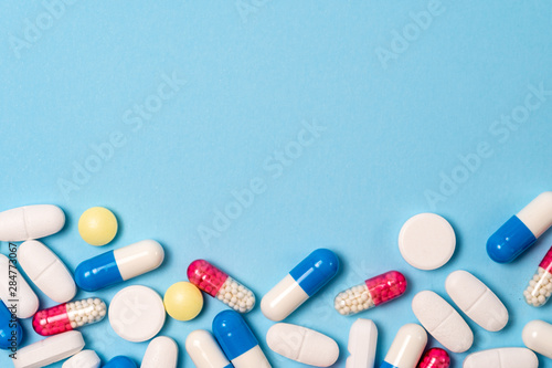 Studio shot of medical pills on blue background photo