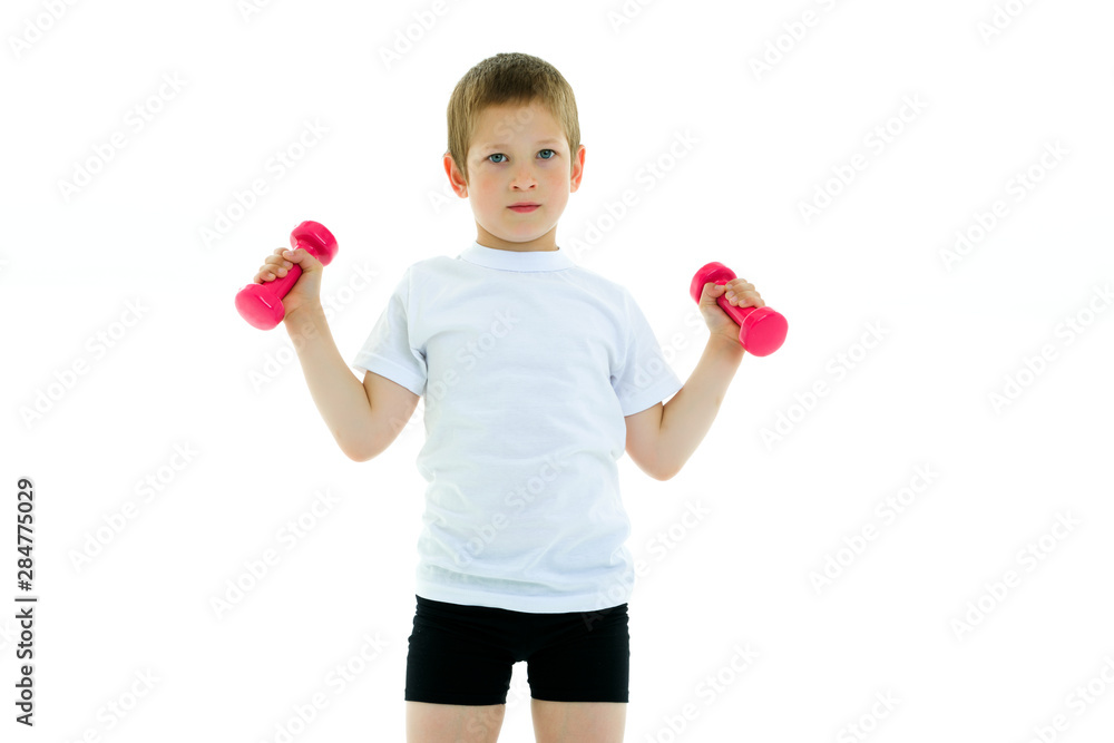 A little boy is lifting dumbbells.