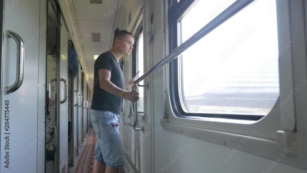 Traveler in railroad car or train wagon looking in window Traveler in railroad car or train wagon looking in window